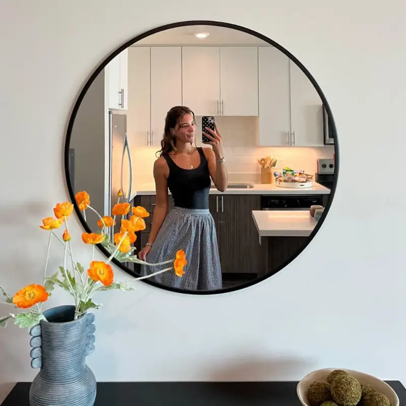 young woman taking a selfie in a mirror