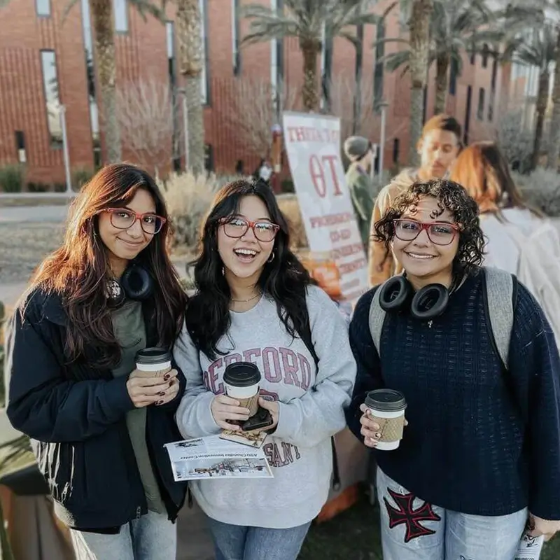 group of young women holding coffee cups