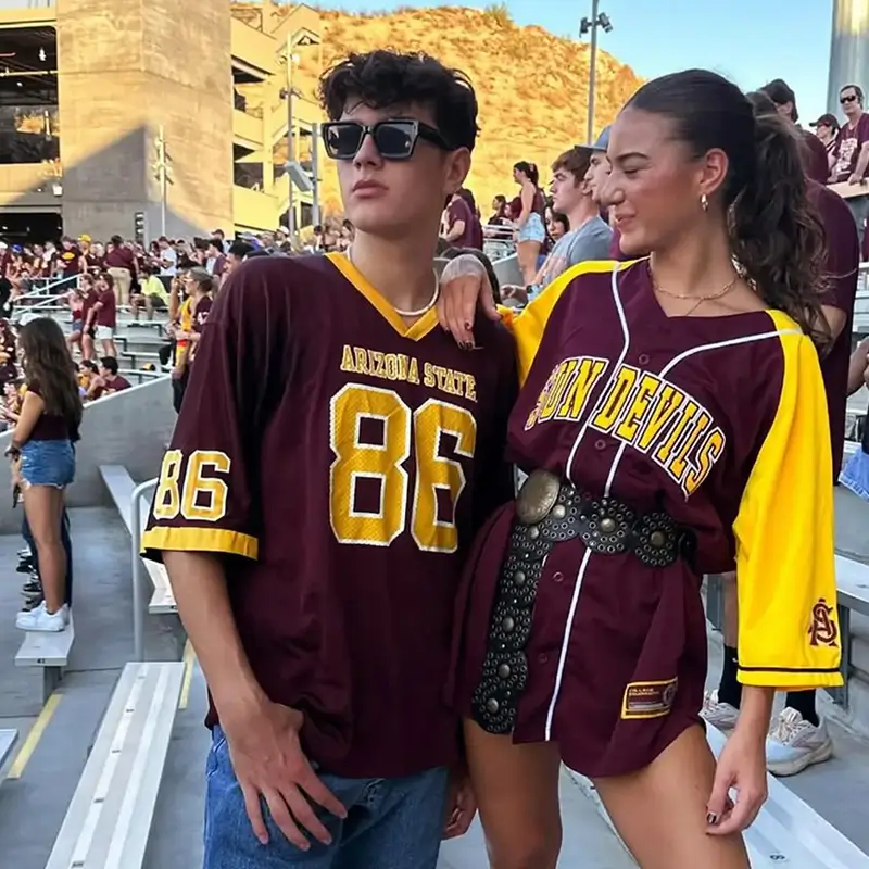 two young adults at a football game