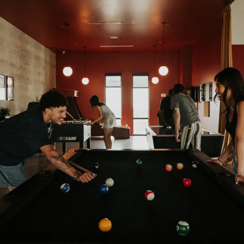 young adults playing pool